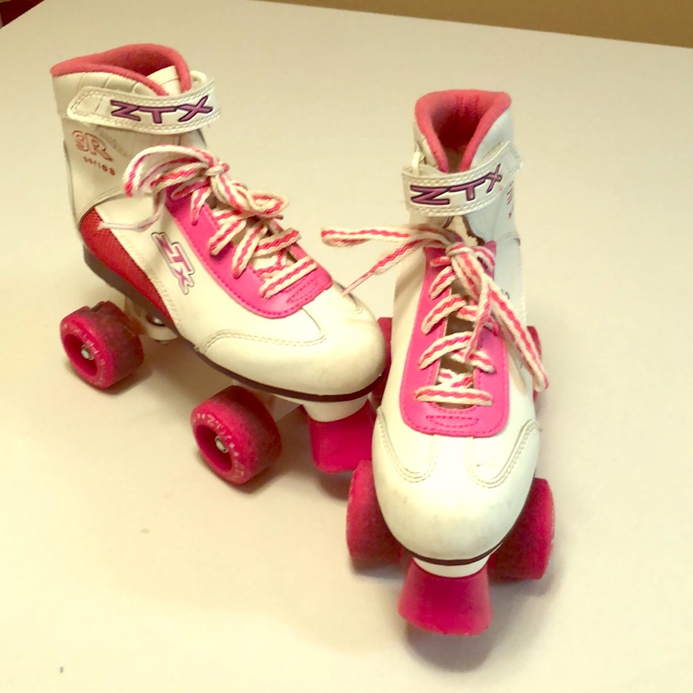 Pink and White ZTX SR series quad roller skates